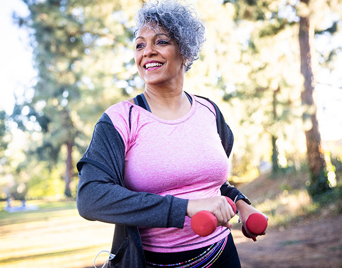 A beautiful black woman using weights during her workout