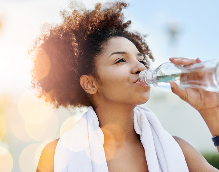woman enjoying a bottle of water